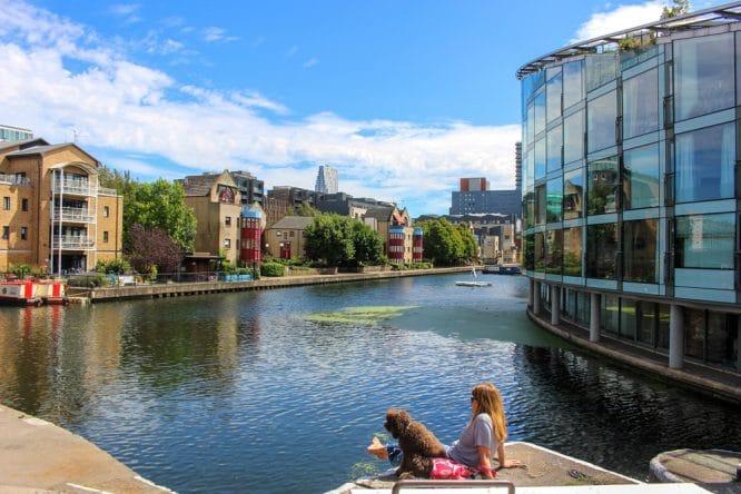 A woman sat with her dog overlooking the Regent's Canal in North London