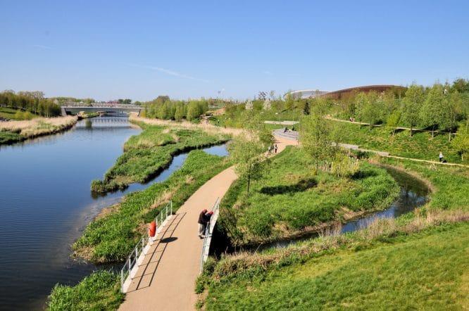 People taking a walk past the River Lea in East London
