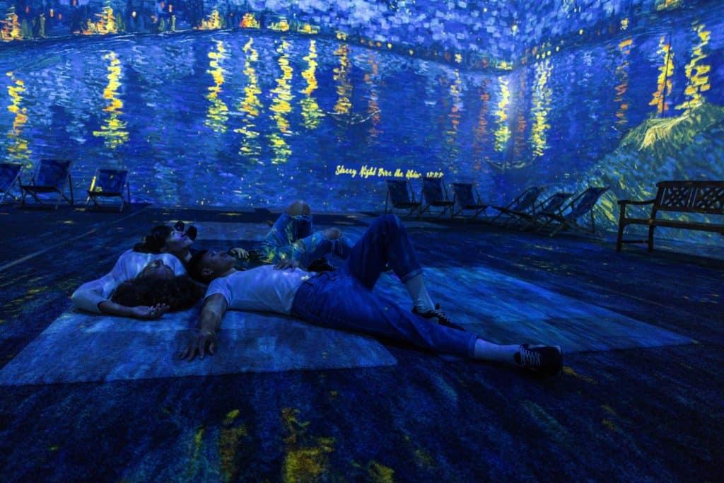 People enjoying the immersive experience of Van Gogh in East London